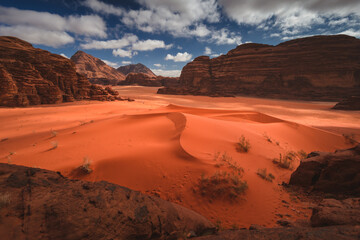 Fototapeta na wymiar Amazing and spectacular landscapes of Wadi Rum desert in Jordan. Dunes, rocks, it's all here. Beautiful weather gives the climate to this place.