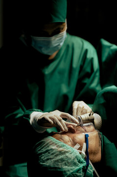The specialist anesthetizes the patient preparing for treatment in the operating room, emergency room.
