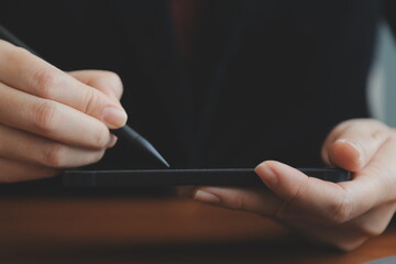 Asian Businesswoman Using laptop computer and working at office with calculator document on desk, doing planning analyzing the financial report, business plan investment, finance analysis concept.