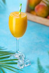 Mango juice isolated on blue background