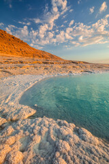 Landscapes from the Dead Sea in the light of the golden hour - interesting salt formations make an amazing impression.