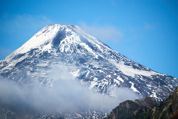 Fototapeta na wymiar View of the Villarrica volcano during the autumn season with snow on its summit.