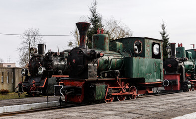 Fototapeta premium Retro locomotive, steam train parked in an outdoor depot.
