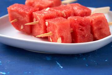 Finger food sticks with with watermelon cubes.