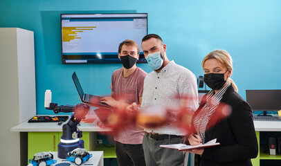  A group of students working together in a laboratory, dedicated to exploring the aerodynamic capabilities of a drone