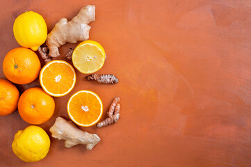 orange, lemon, ginger and turmeric on an orange background