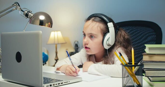 Girl Child Studying in Online Kolas at Home. Back to School, Online Learning, Distance Lesson, Homeschooling, School Technology, Tutored Lessons. Children Doing Homework at Home
