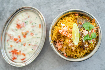 Spicy Indian biryani pulao in golden bowl with India basmati rice dish with chicken meat curry