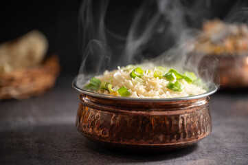 Smoky white rice. Prepared and served in a brass bowl