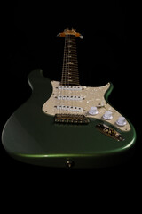 Stratocaster style electric guitar floating on black background