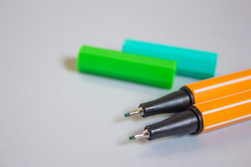 Colorful markers on a grey background with copy space.