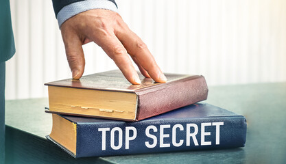 Top Secret text concept write on book on wooden background