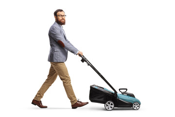 Full length shot of a man using a lawnmower and looking at camera