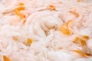 macro shot of sauerkraut. Close-up view of a piece of sour sauerkraut with carrots. Home salad. fermented food
