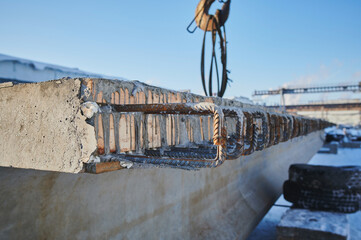Row of reinforced concrete foundations with metal anchor bolts designed for the installation of...