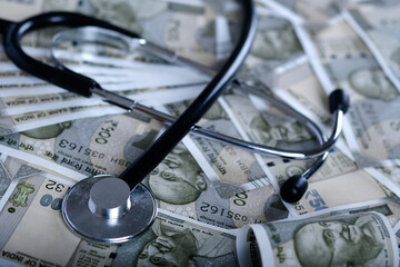 Stethoscope on indian 500 rupee notes, Concept of health and business showing Indian paper currency...