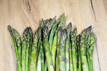 Green fresh bunch of a asparagus on wooden background. Healthy diet food. Vegetarian food.