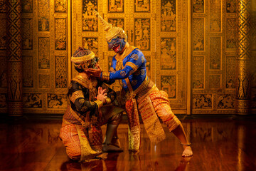 Fototapeta premium Khon or traditional Thai classic masked from the Ramakien with black and blue monkey stand together with action of traditional dance with Thai paintings background.