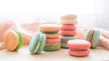 Multicolored macarons on the wooden tray 