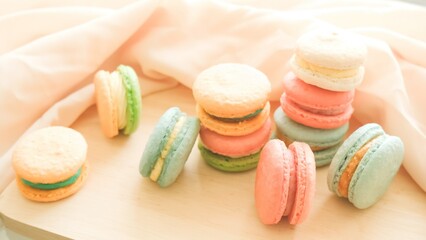 Multicolored macarons on the wooden tray 