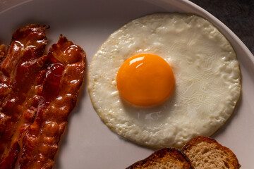 Perfectly Fried Egg with Crispy Bacon and Toast