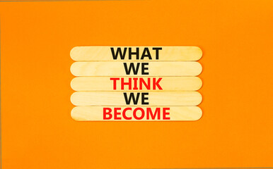 We become or think symbol. Concept word What we think We become on wooden stick. Beautiful orange table orange background. Business we become or think concept. Copy space.