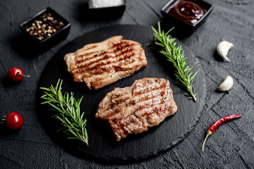 grilled veal steaks on stone background