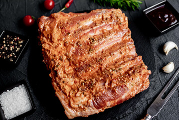 marinated raw pork ribs on stone background