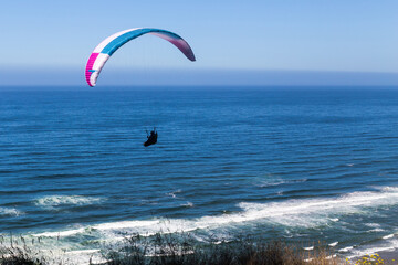 Paragliding flight over the Pacific coastline