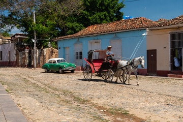 Horse-drawn carriage in the alleys and historic districts of Trinidad with the San Francisco de Asis church