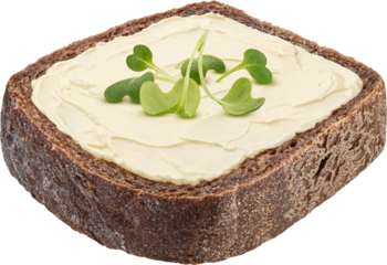 Slice of rustic rye bread with smeared butter isolated on white background with clipping path