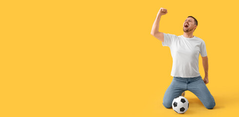 Happy screaming man with soccer ball on yellow background with space for text