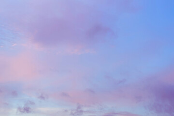 Obraz premium Twilight sky with effect of light in pastel pink, coral, orange, blue tones. Colorful sunset of soft clouds. Background