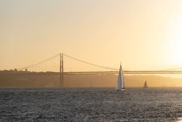 Leisure sailing yacht heading into Lisbon harbour at sunset