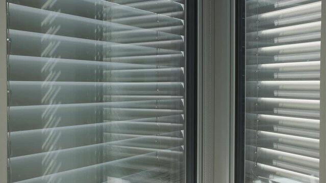 automated external blinds opening in a skyscraper office building 