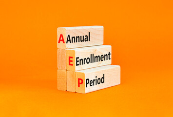 AEP symbol. Concept words AEP Annual enrollment period on beautiful wooden block. Beautiful orange table orange background. Medical and AEP Annual enrollment period concept. Copy space.