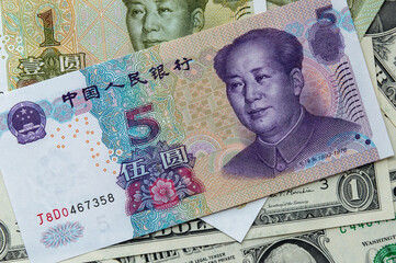 A composition featuring a 5 yuan banknote on the top, accompanied by a 1 yuan and 1 USD banknote.