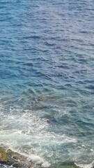 Genova, Italy - May 11, 2023: Beautifull seascape in spring. Blue sky hot weather and calm sea. Mediteranean seascape colours. Small waves near the rocks.