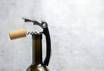 wine opener accessories tools,rose bottle and brie camembert cheese isolated gray tiles...