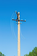 Electric Power Pole with Broken Wires at Sunny Summer Day