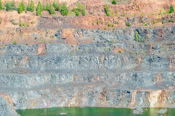 Industrial Terraces of Old Abandoned Stone Quarry with a Lake at the Bottom