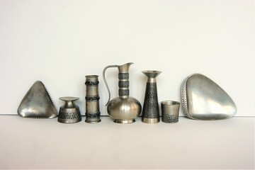 Pewter items with design pattern from the 1960s.