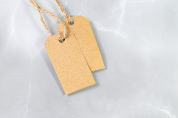 Blank tag tied with natural material string. Price tag, gift tag, sale tag, address label.

