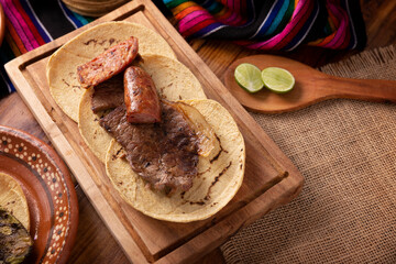 Taco campechano style, Carne Asada. (roast meat) and chorizo or longaniza, very popular dish in northern Mexico, also called Asado, Discada or Parrillada.