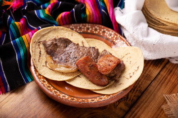 Taco campechano style, Carne Asada. (roast meat) and chorizo or longaniza, very popular dish in northern Mexico, also called Asado, Discada or Parrillada.