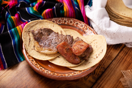 Taco campechano style, Carne Asada. (roast meat) and chorizo or longaniza, very popular dish in northern Mexico, also called Asado, Discada or Parrillada.