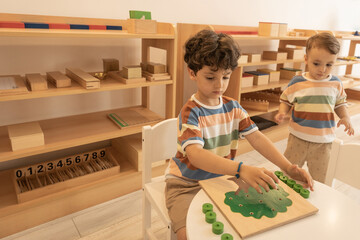 Children playing with wooden toys in the kindergarten
