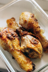 Fried chicken legs lie on a plate after cooking
