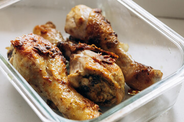 Fried chicken legs lie on a plate after cooking