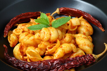 Gnocchetti sardi pasta in tomato sauce. gray background. Italian food concept